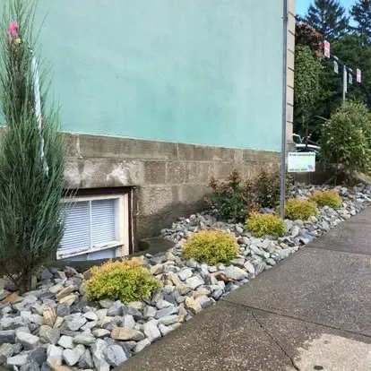 Commercial bed cleanup with trimmed shrubs