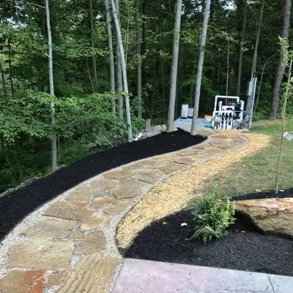 Flagstone pathway with black mulch and gravel border